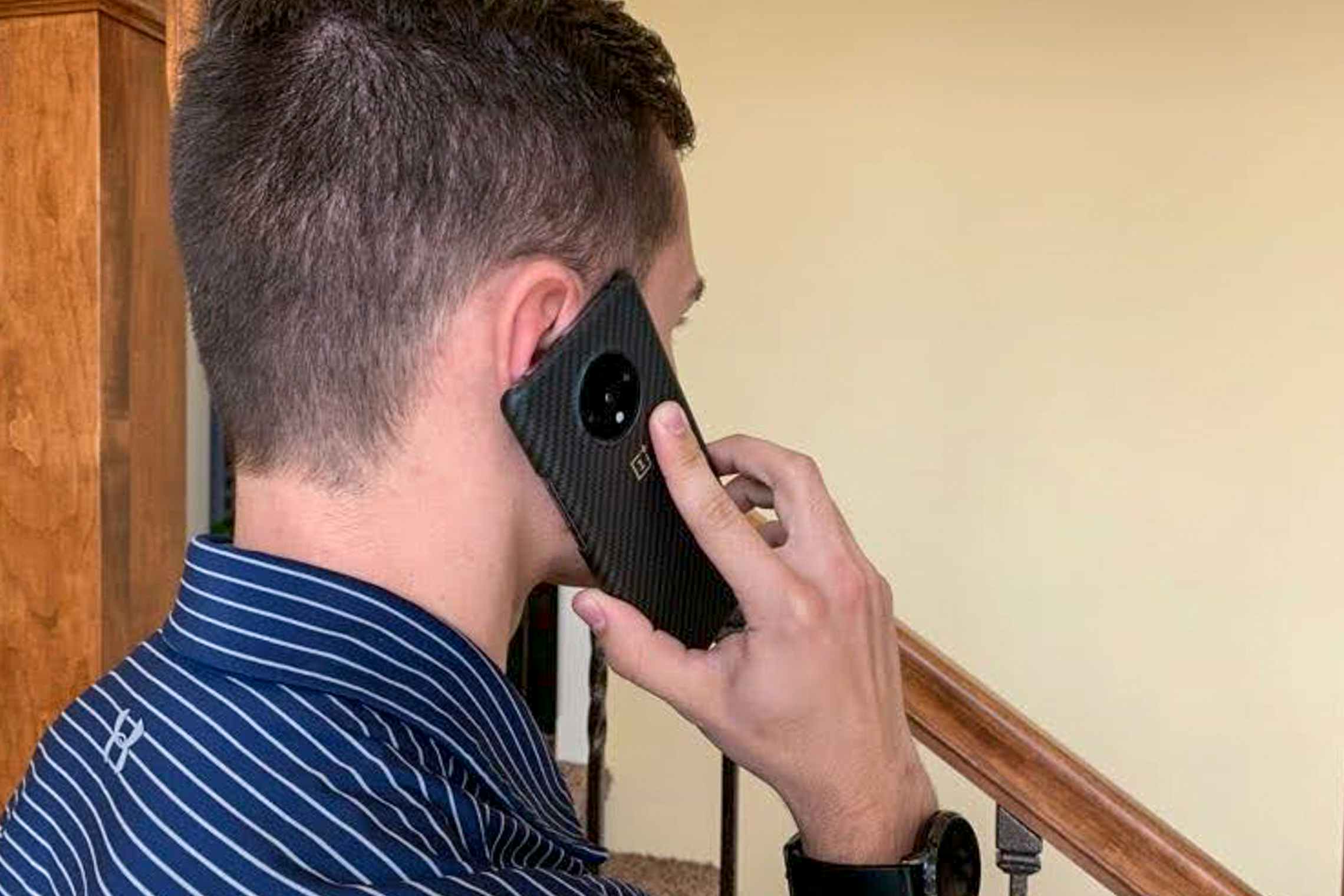 A man holding a phone to his ear like he's talking to someone.
