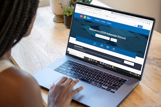 Woman on her laptop looking at lego ambassador group online