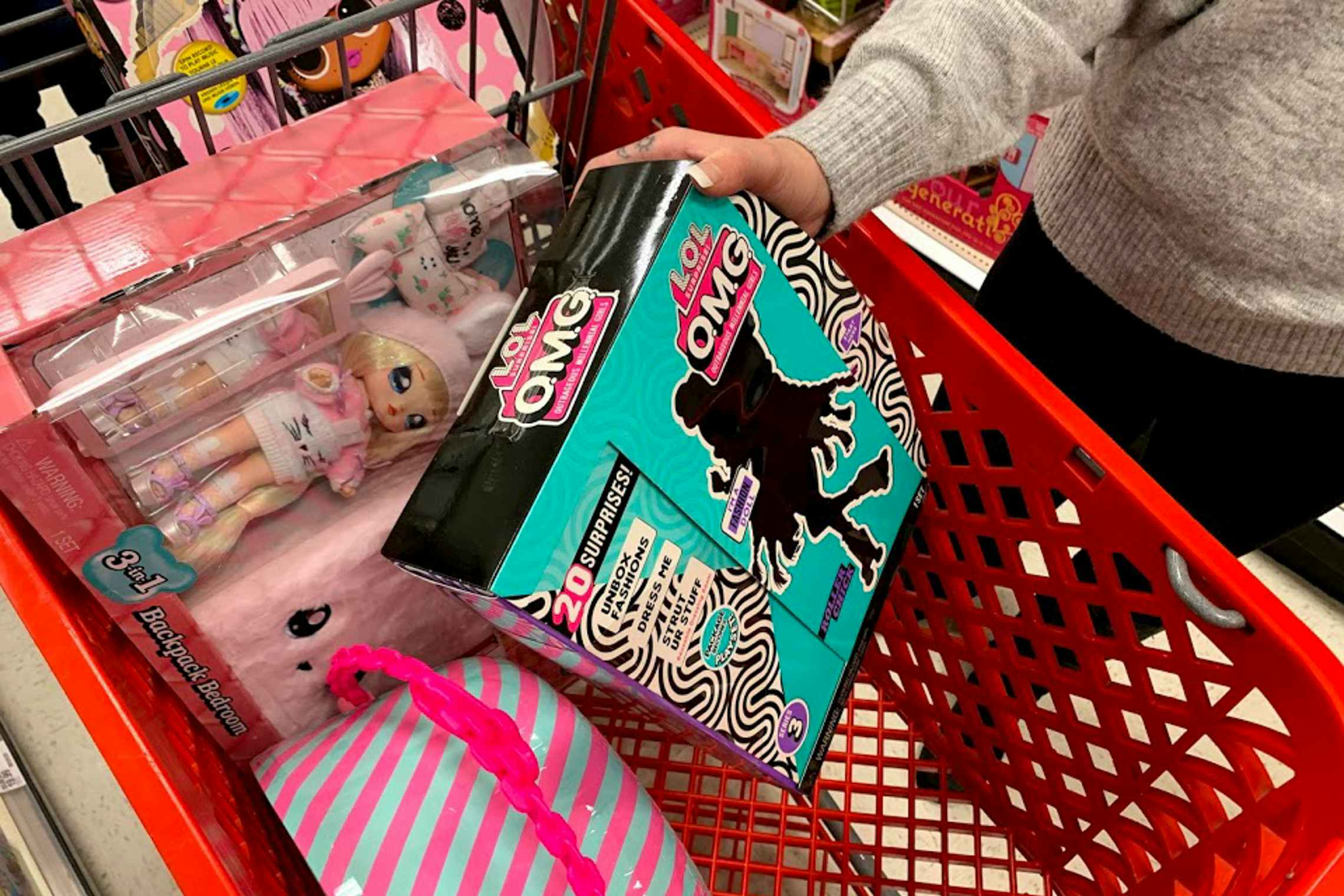Woman loading her shopping cart at target with LOL Surprise doll toys