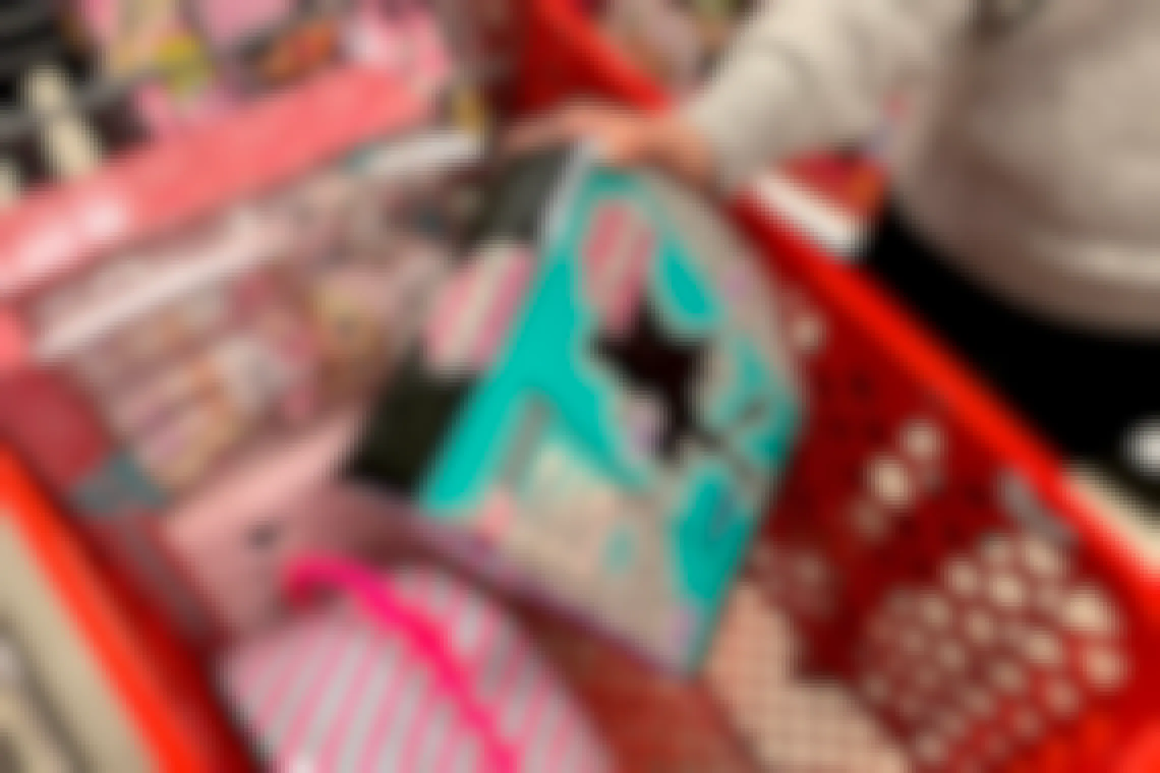 Woman loading her shopping cart at target with LOL Surprise doll toys