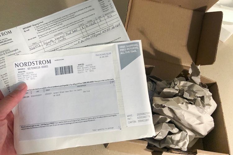 Someone holding delivery receipt with delivery box