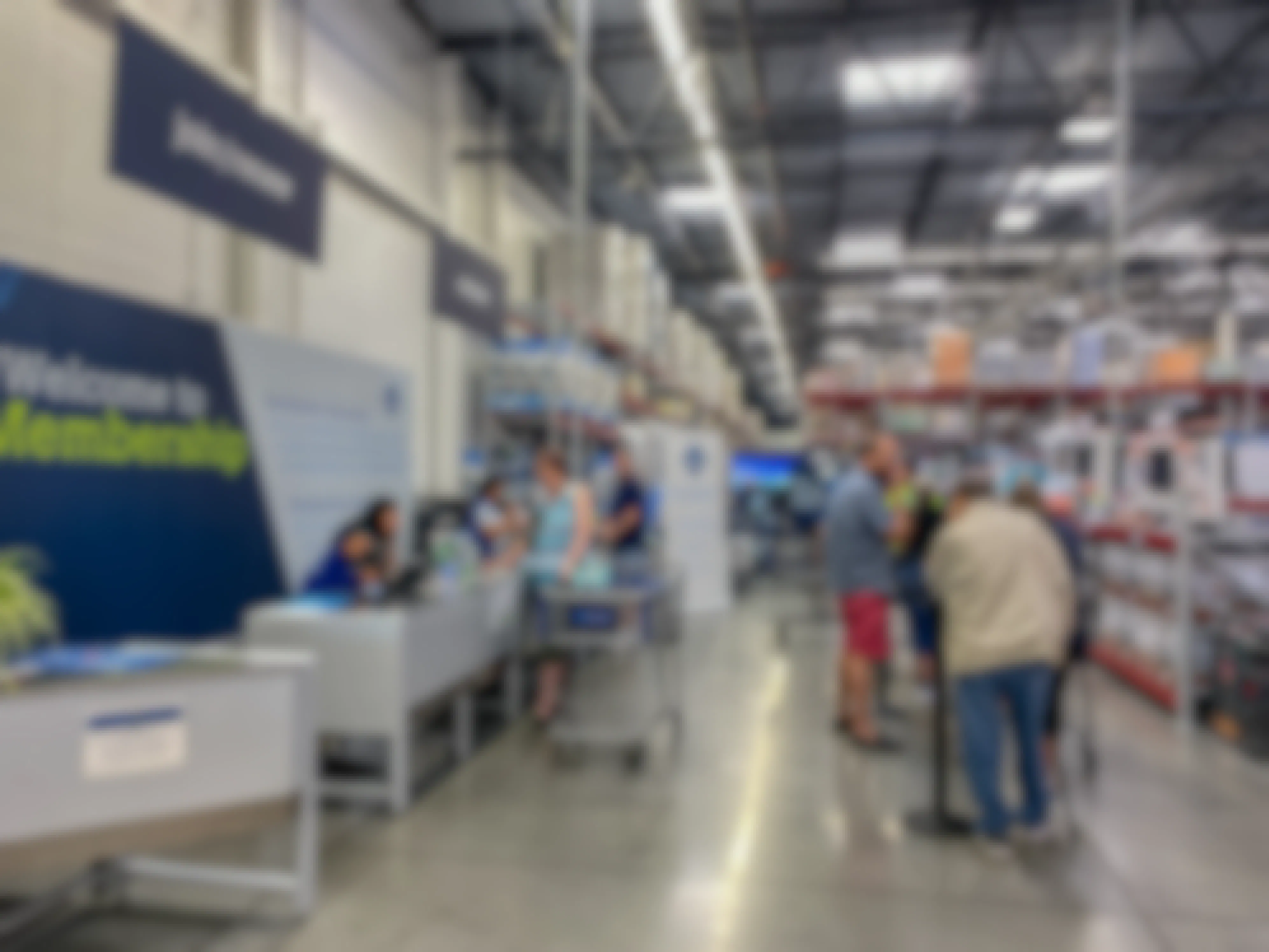 Customers standing in line, waiting to be helped at Sam's Club Customer service and returns counter.