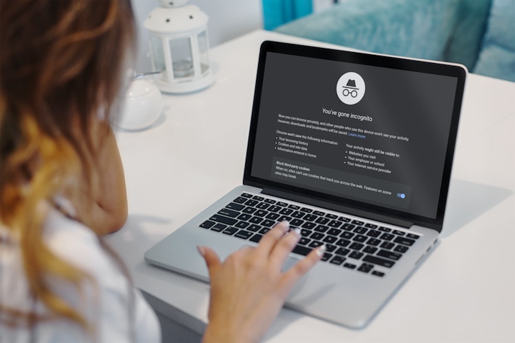 woman browses incognito on her laptop while holiday shopping online