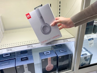 A woman holding Beats headphones