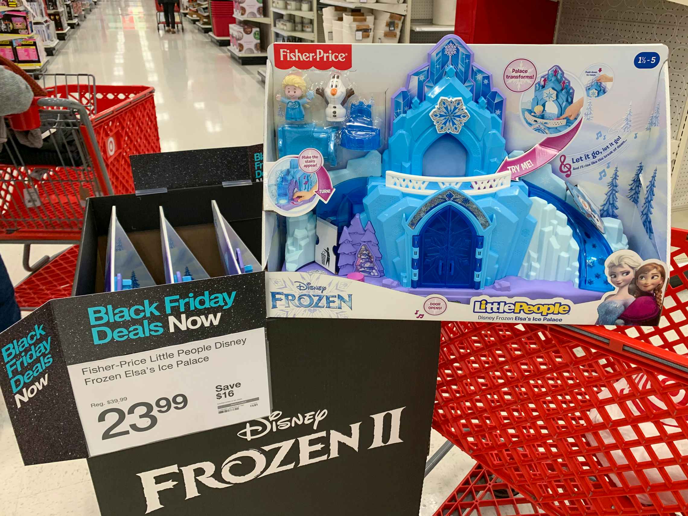 Disney Frozen little people ice palace toy next to a black friday sales tag reading $23.99 at Target