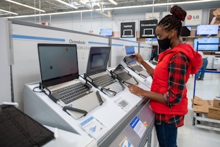 A woman looking at Chromebook laptop computers at Walmart
