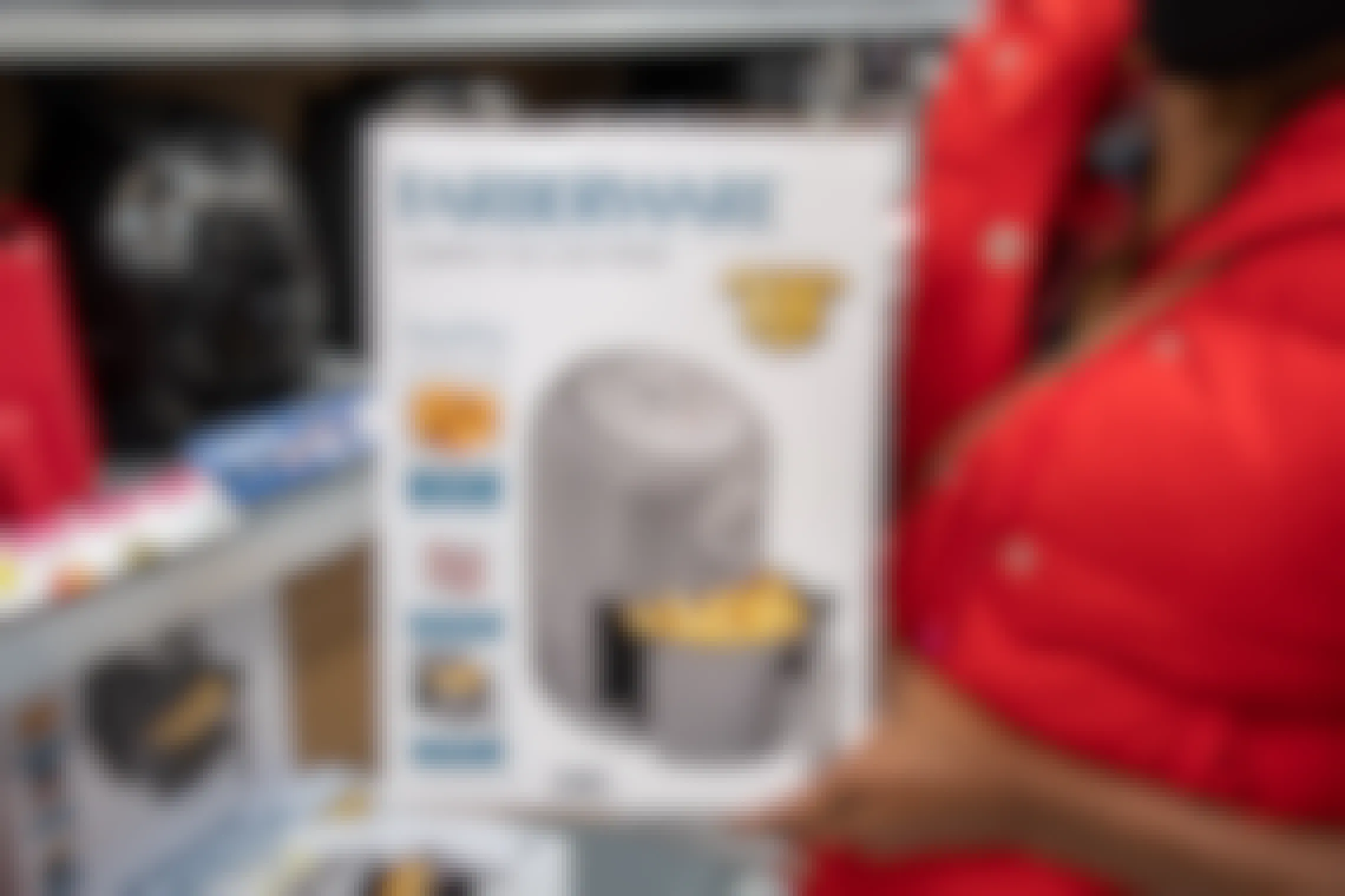 Woman holding a Farberware air fryer at Walmart