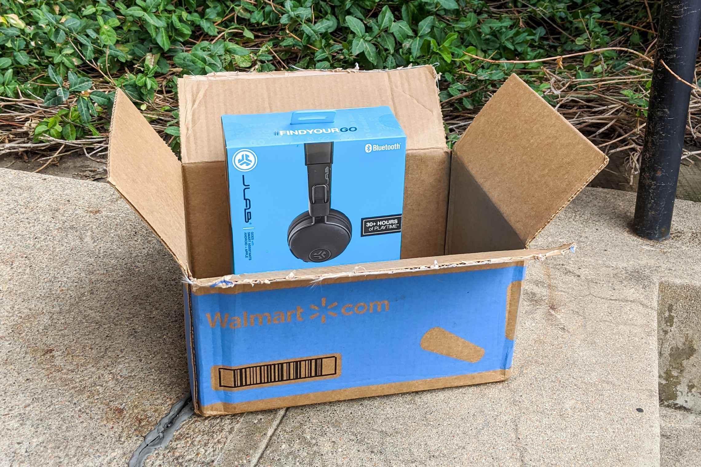 Headphones in an open Walmart box on doorstep