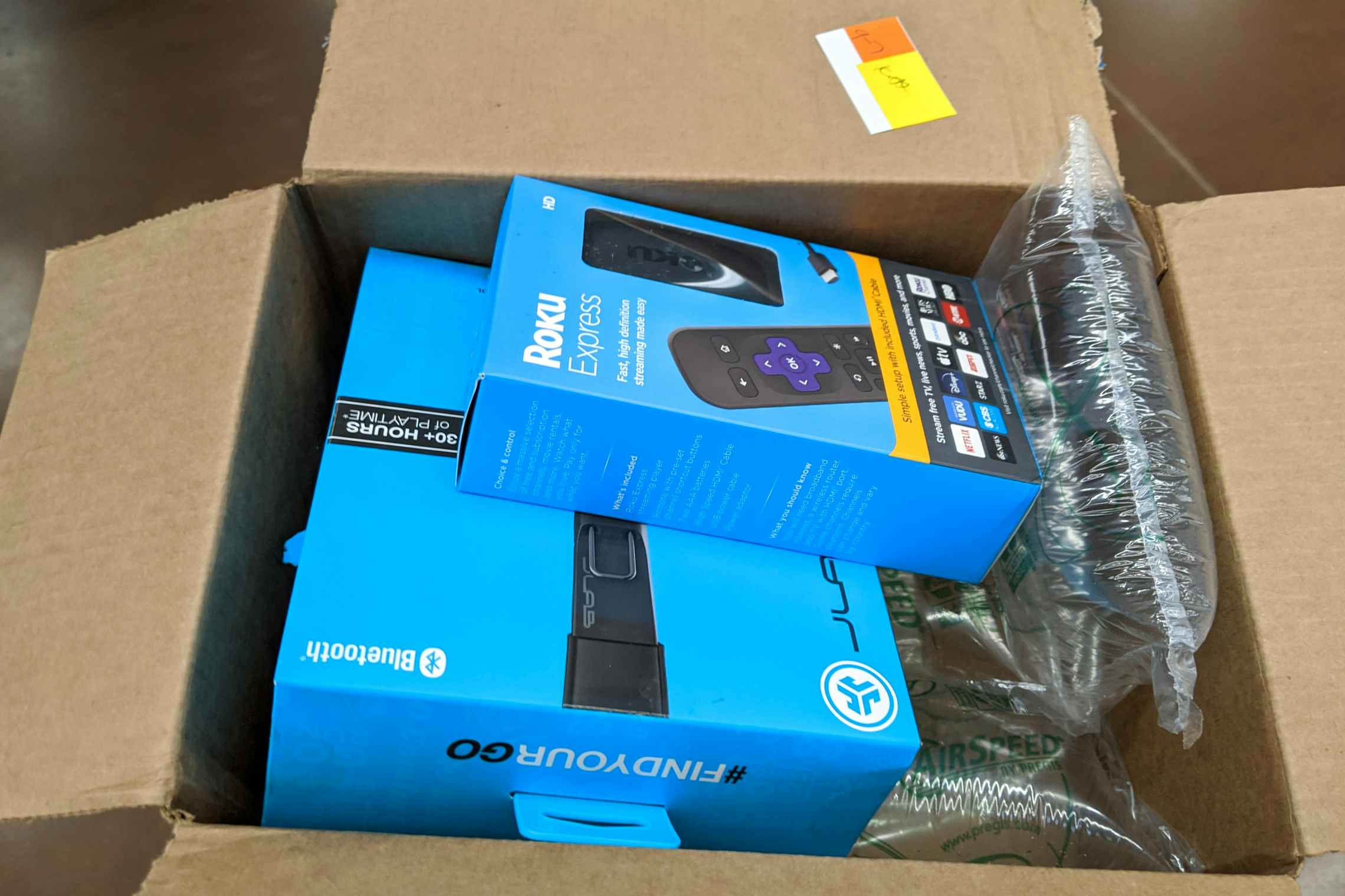 Headphones and roku in an open Walmart box