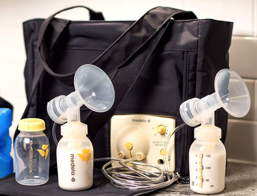 A breast pump bag and bottles sitting on a counter.