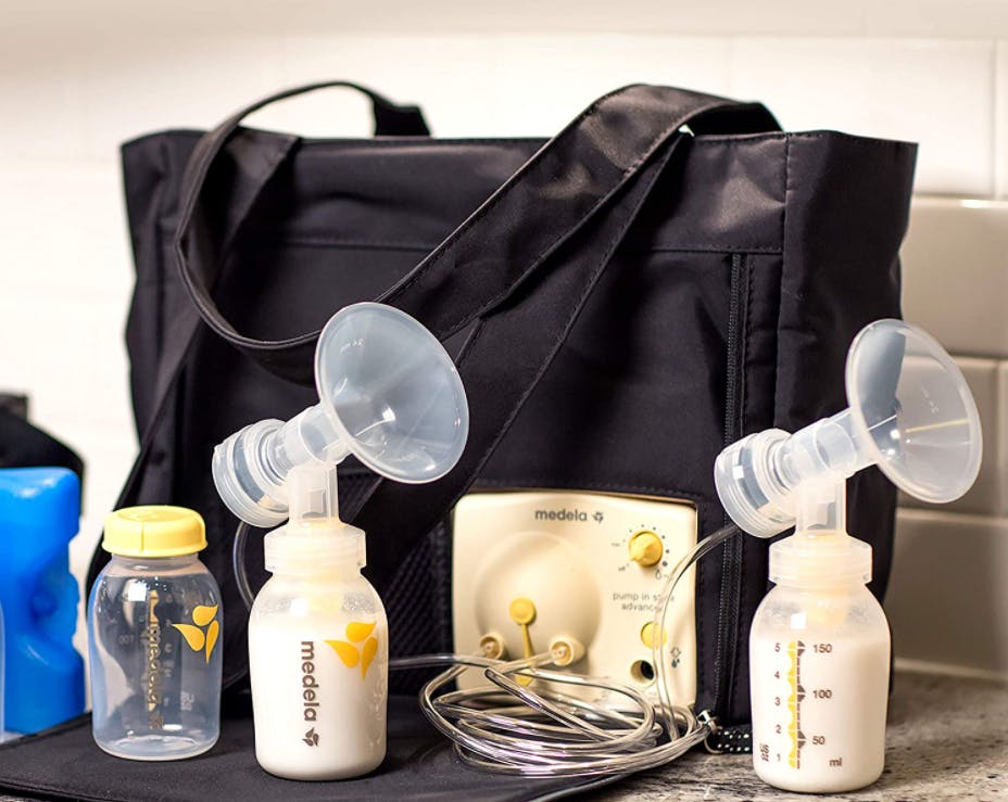 A breast pump bag and bottles sitting on a counter.