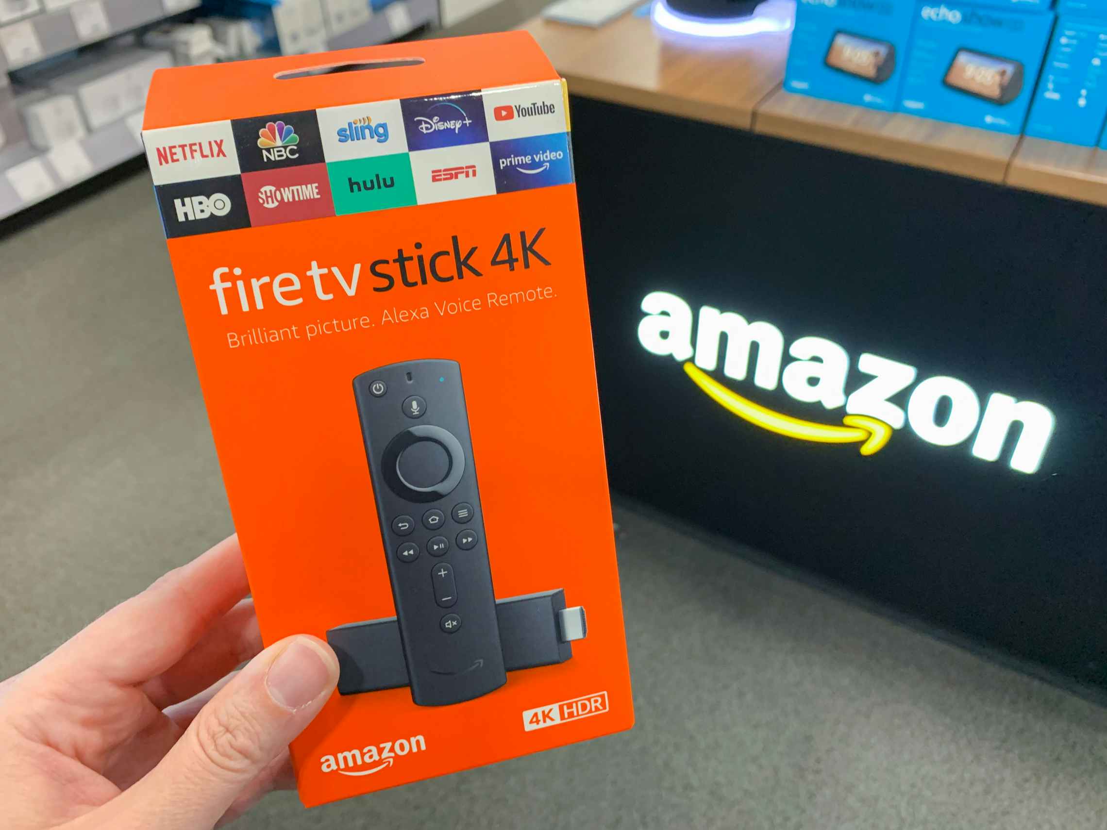 amazon fire tv stick being held in store 