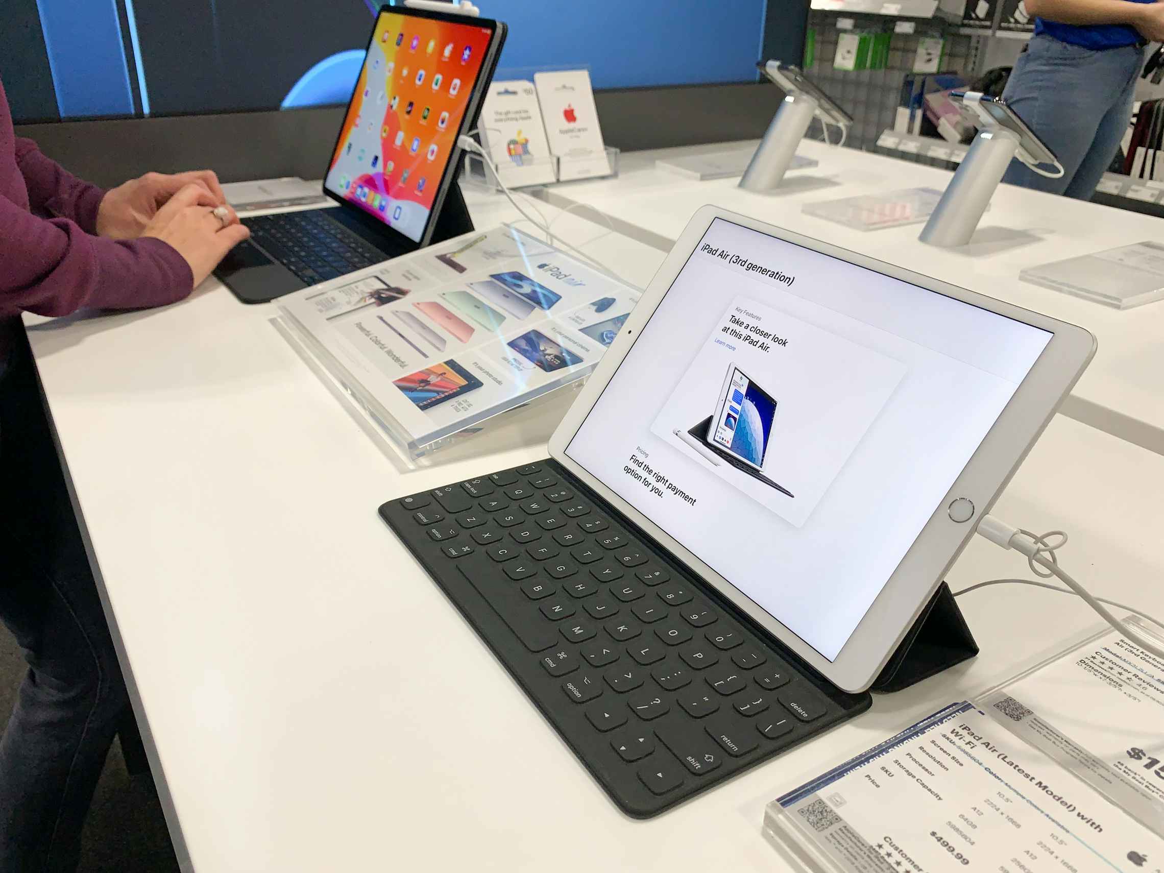 A woman inside Best Buy looking at an ipad.