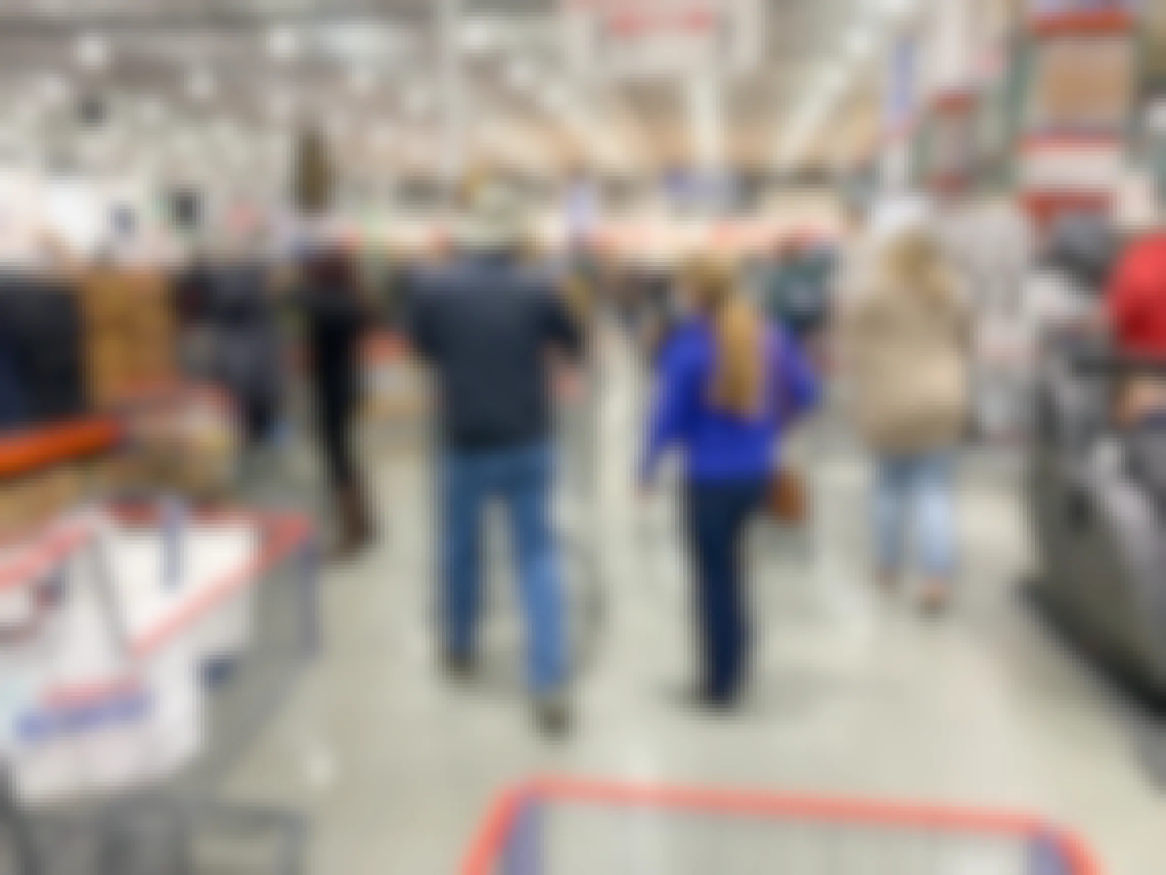 A crowd of people shopping inside Costco