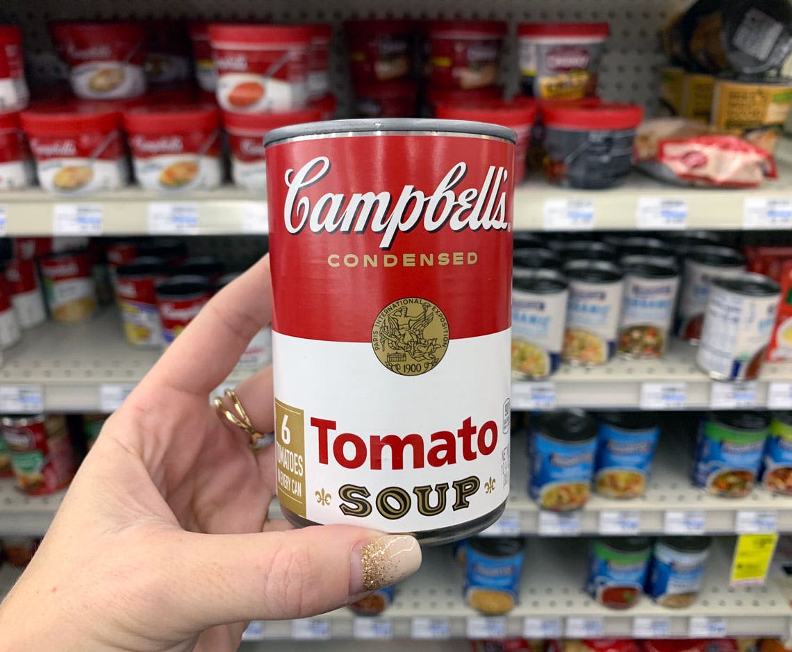 someone holding campbells tomato soup