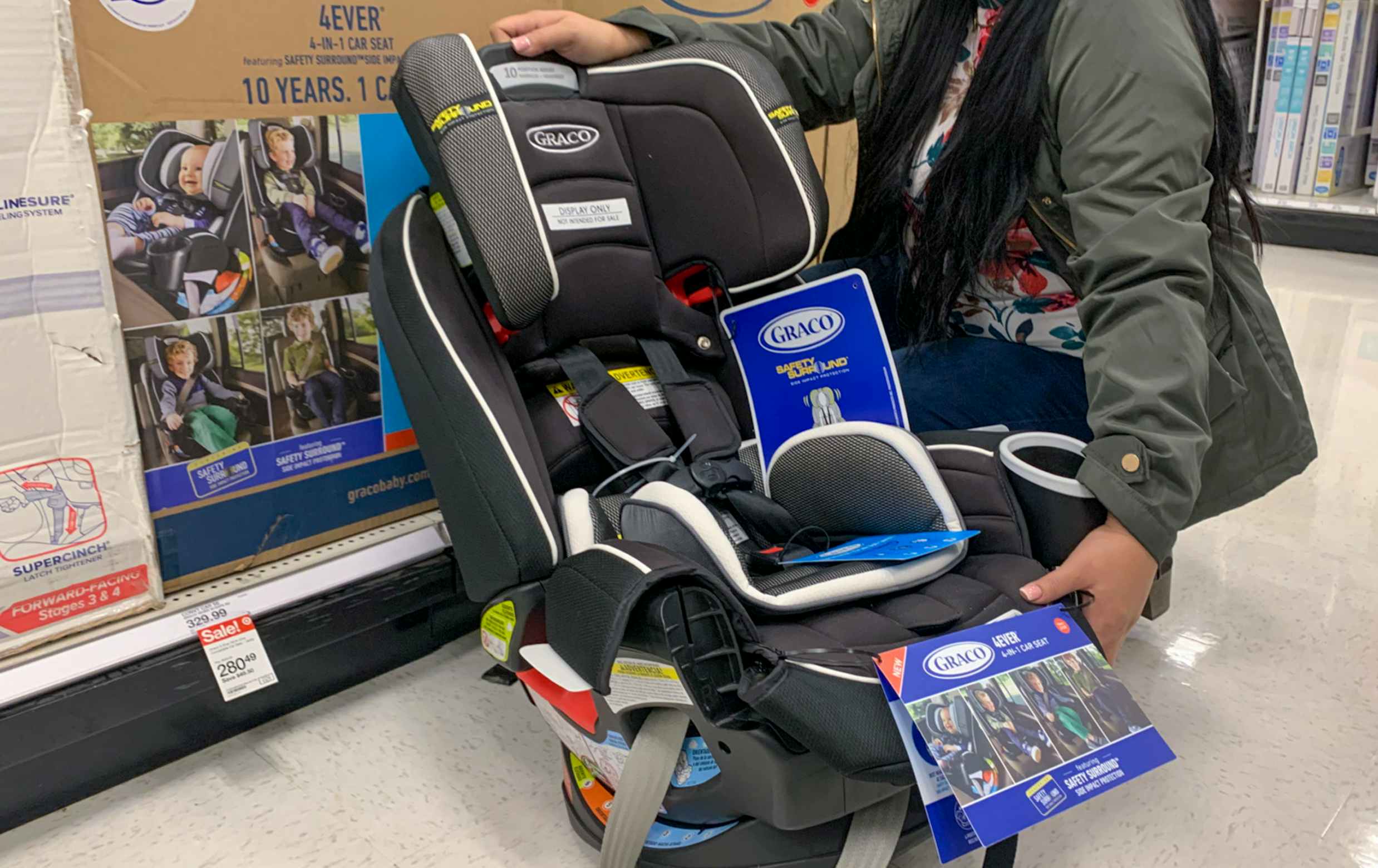 Woman holding graco 4ever car seat