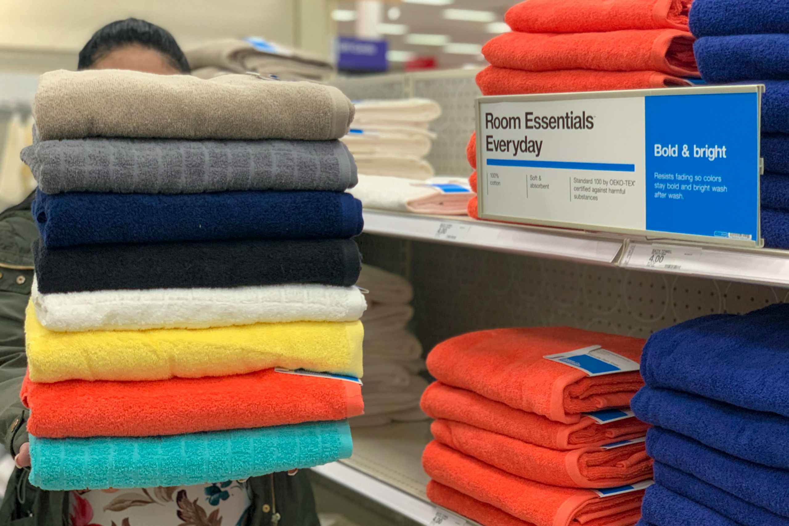 woman holding room essentials everyday towels in target