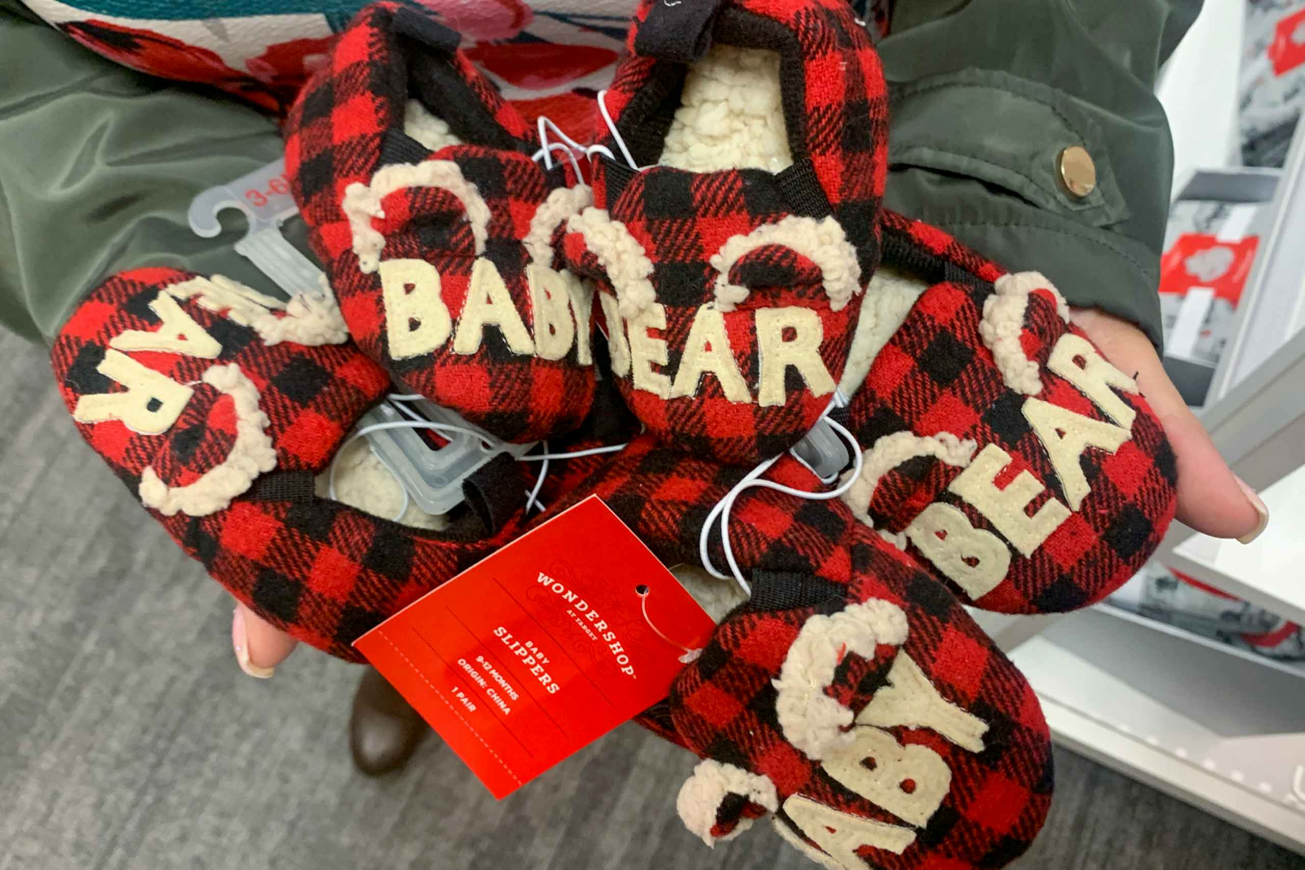 woman holding child christmas slippers at target