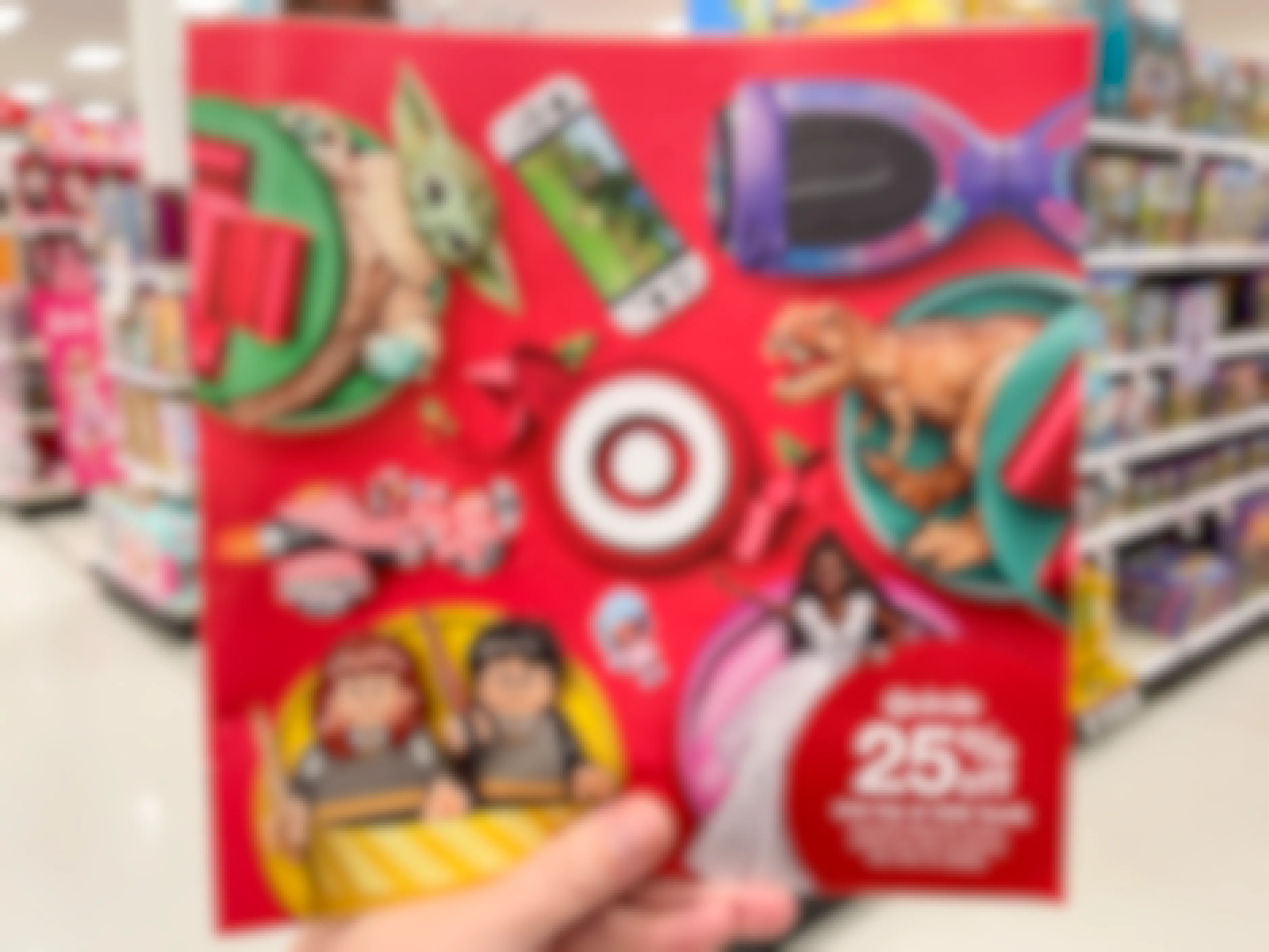 The Target Toy Book ad for 25% off a toy or kid's book being held in a Target toy aisle.