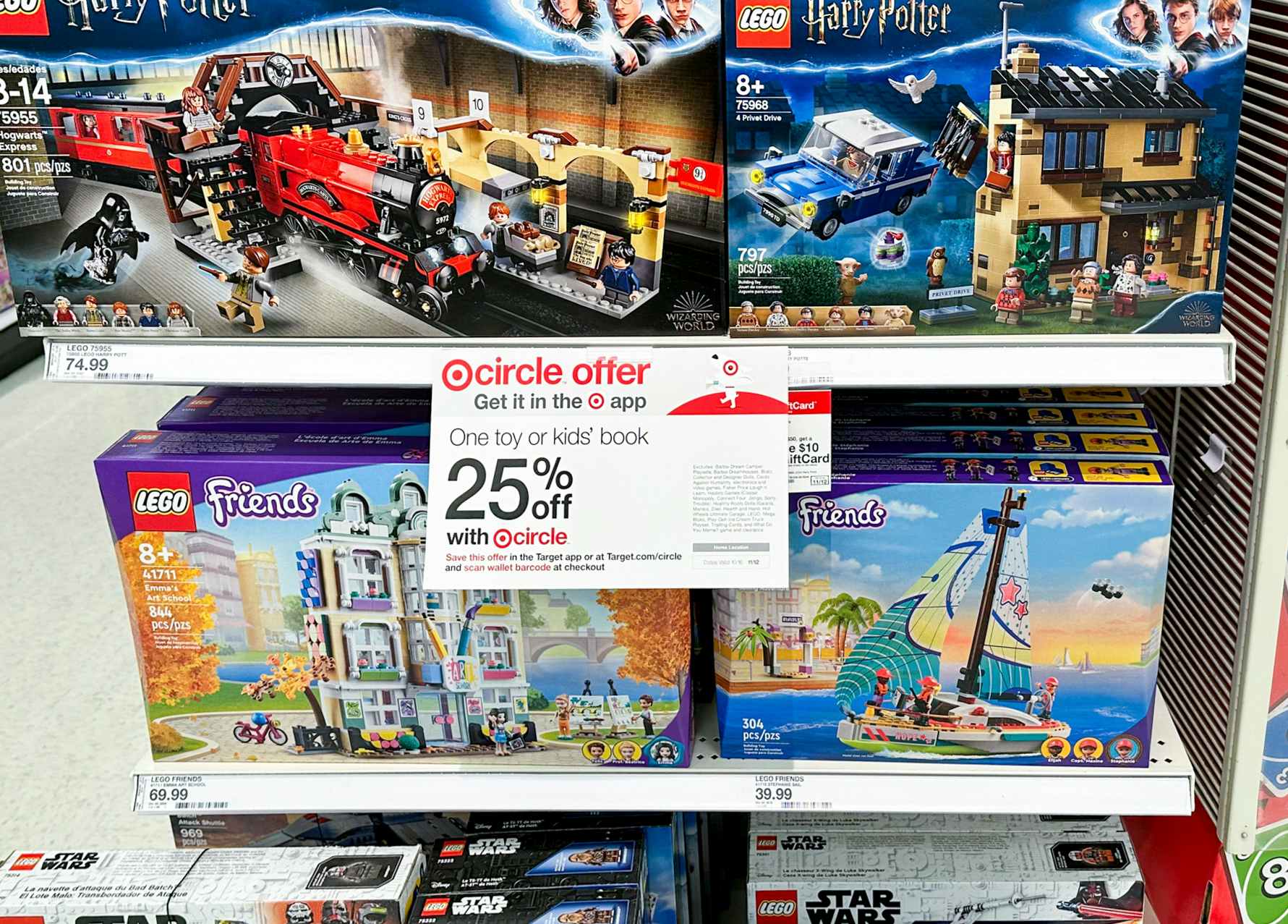 A target circle offer sign for a Target toy sale 25% off coupon on a shelf with LEGO sets