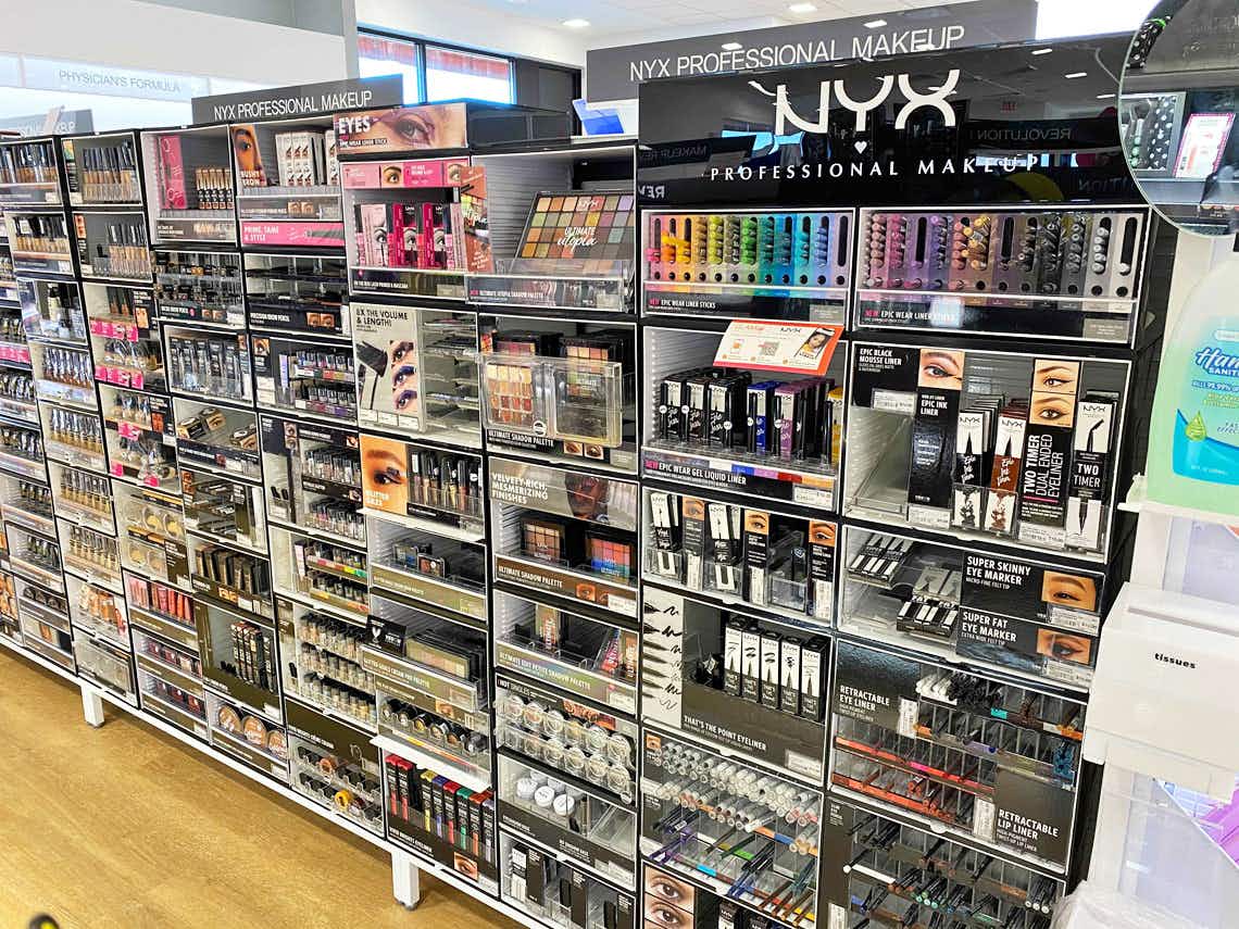 A store aisle featuring various NYX Professional Makeup products.