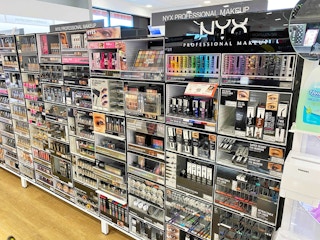 A store aisle featuring various NYX Professional Makeup products.