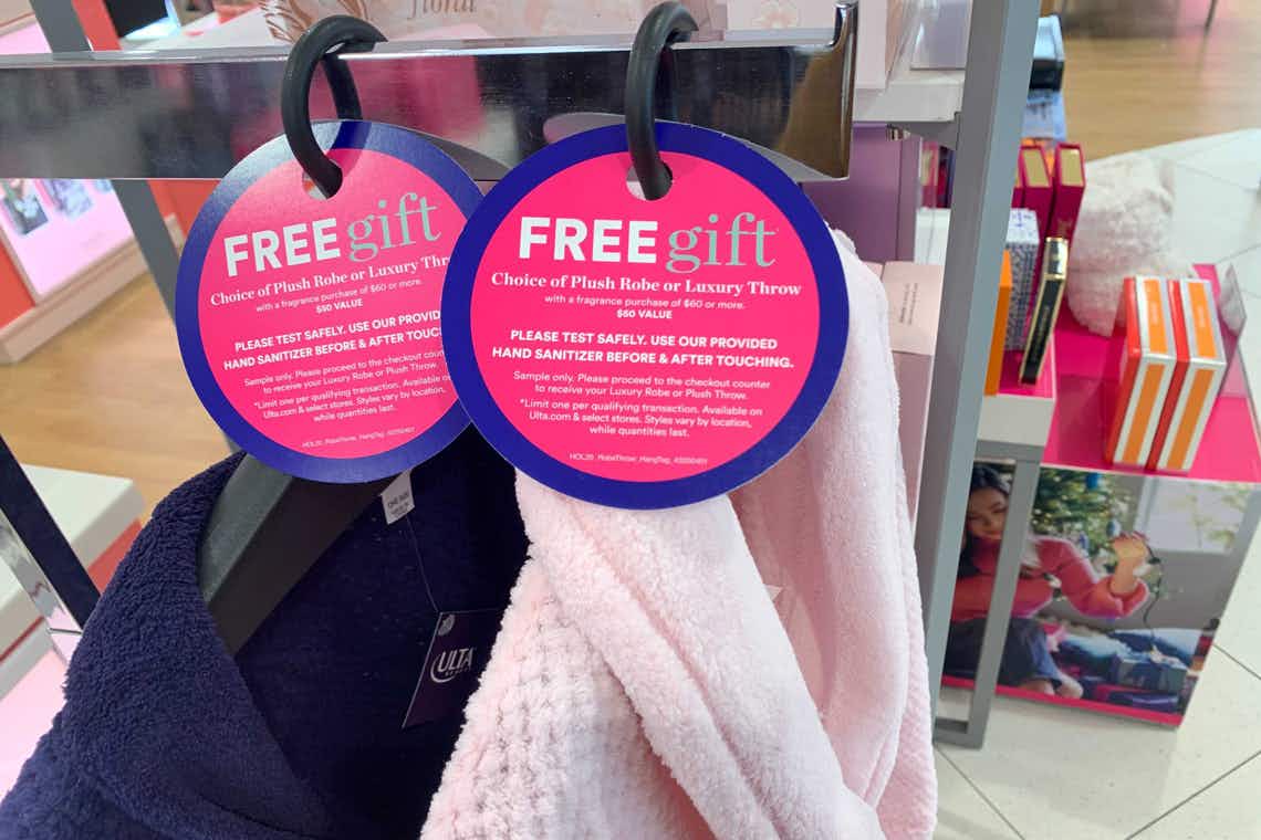 Two robes hanging on a rack with tags that read "Free Gift" at an Ulta store.