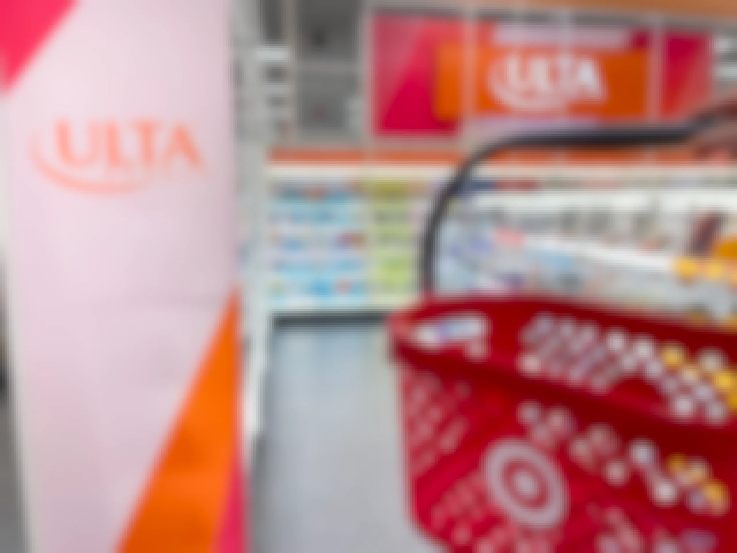 a target hand basket being held in front of ulta sign in the ulta section inside target