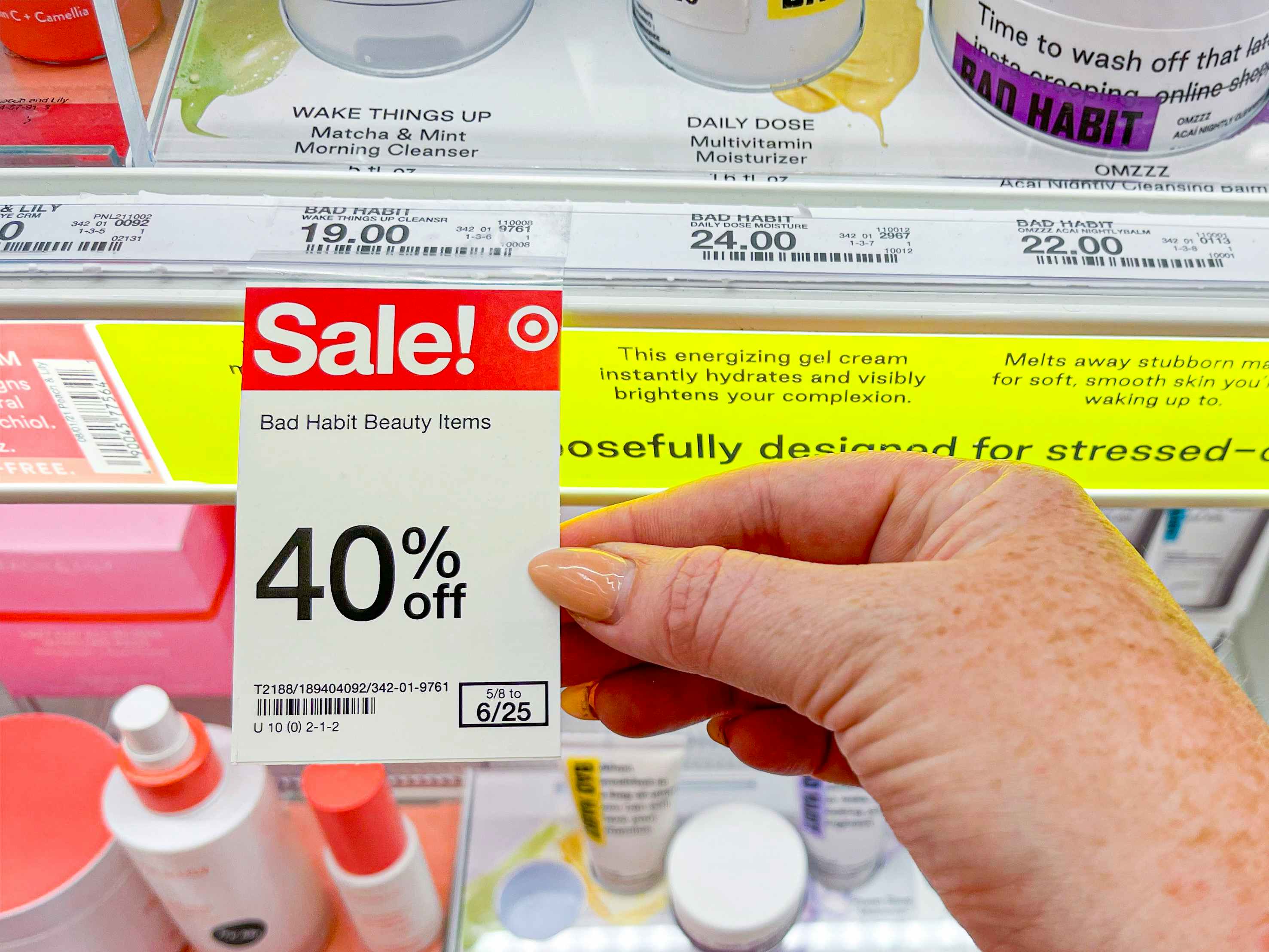 a person touching a sales tag on shelf inside ulta store in target store