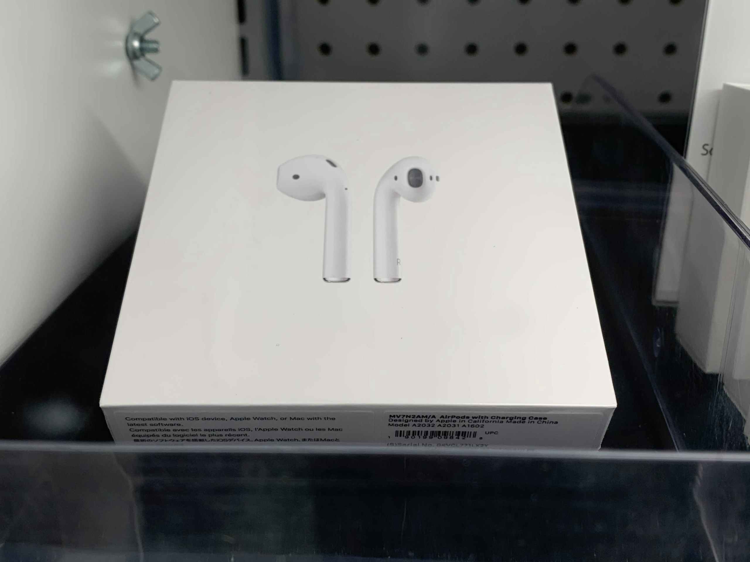 apple airpods in box on shelf in display case