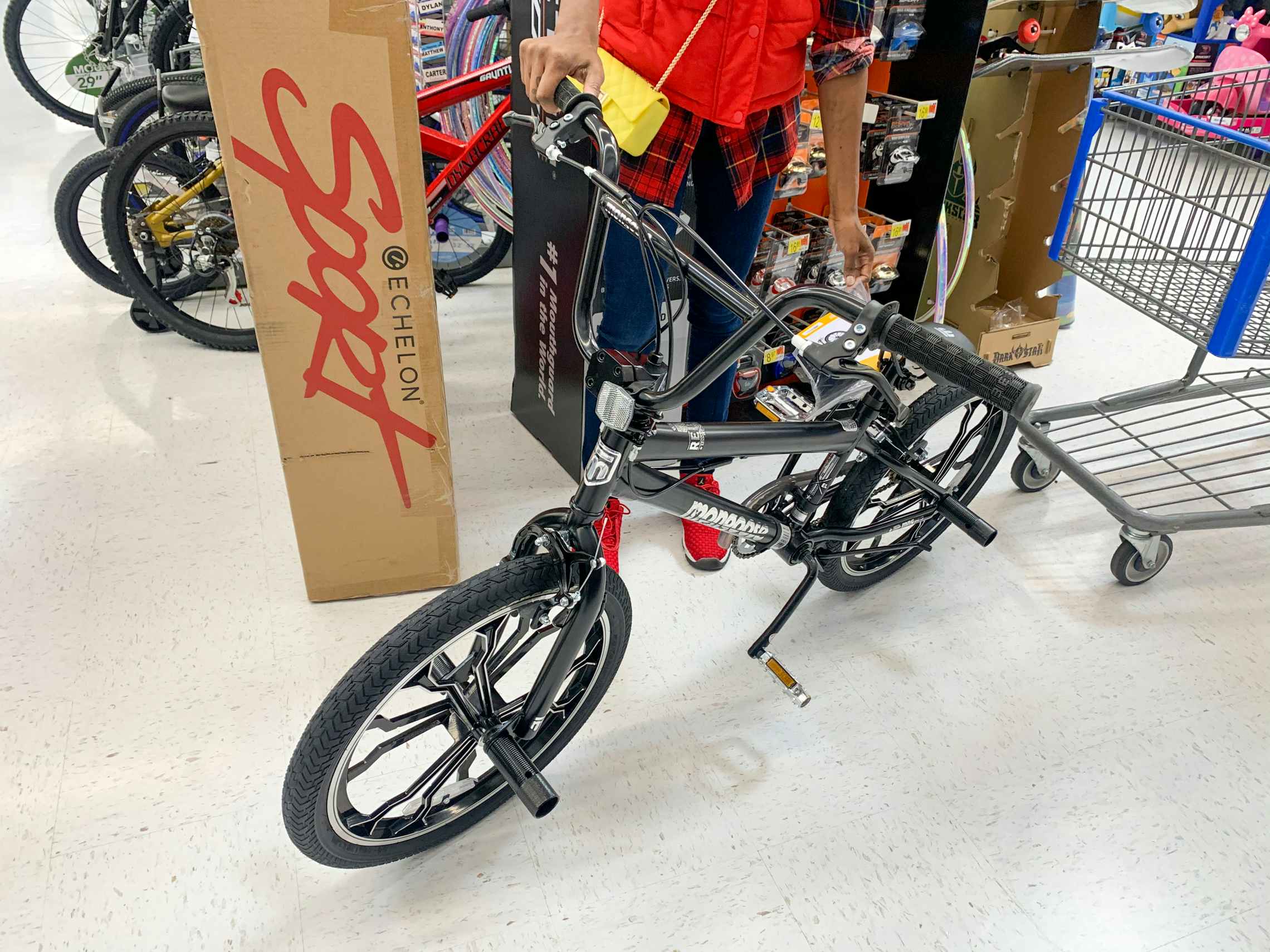 A woman standing next to a Sport Bike inside Walmart
