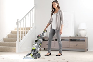 stock photo of hoover pro clean pet carpet cleaner with woman using item in living room