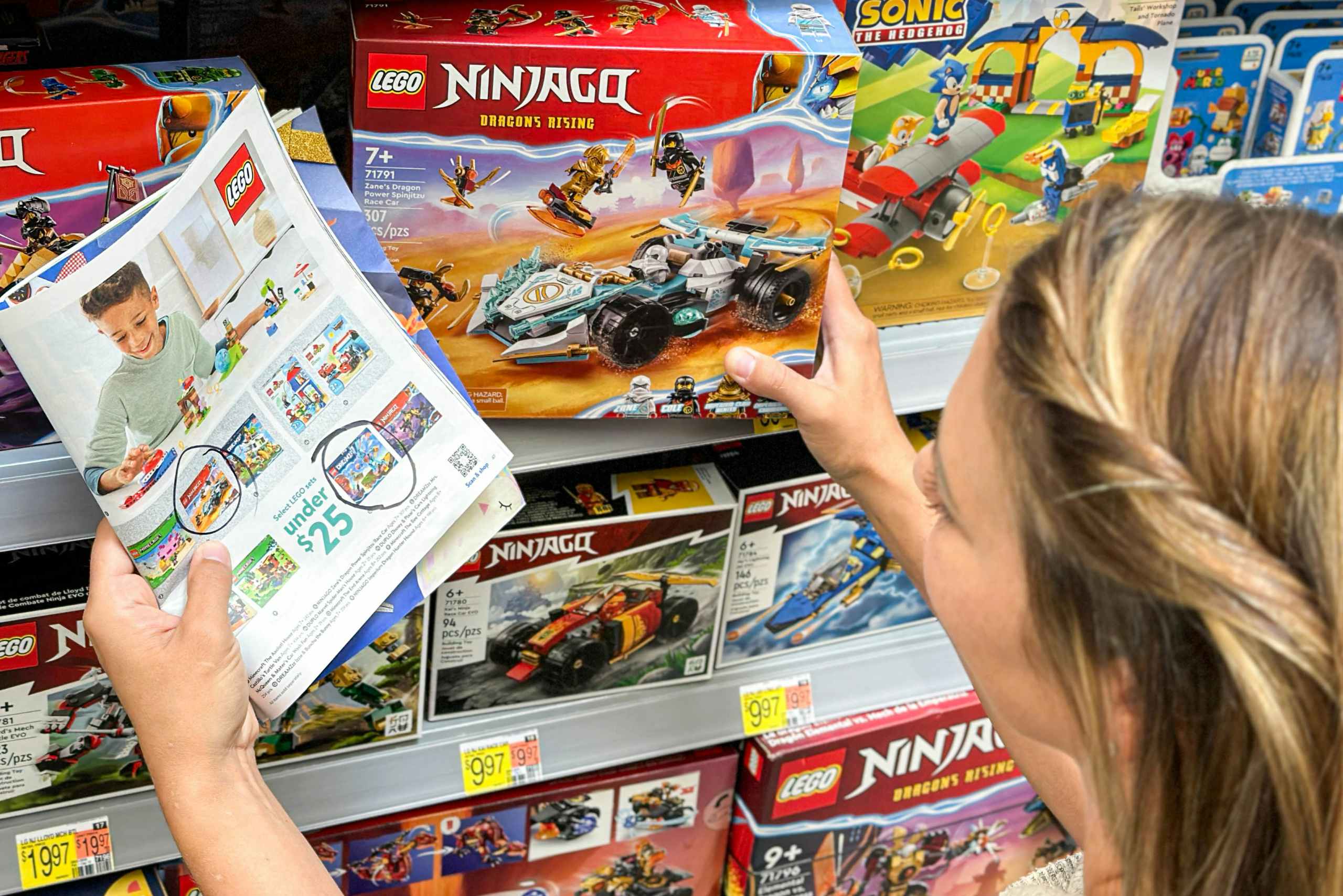 a woamn looking at legos in store while comparing to toy catalog 