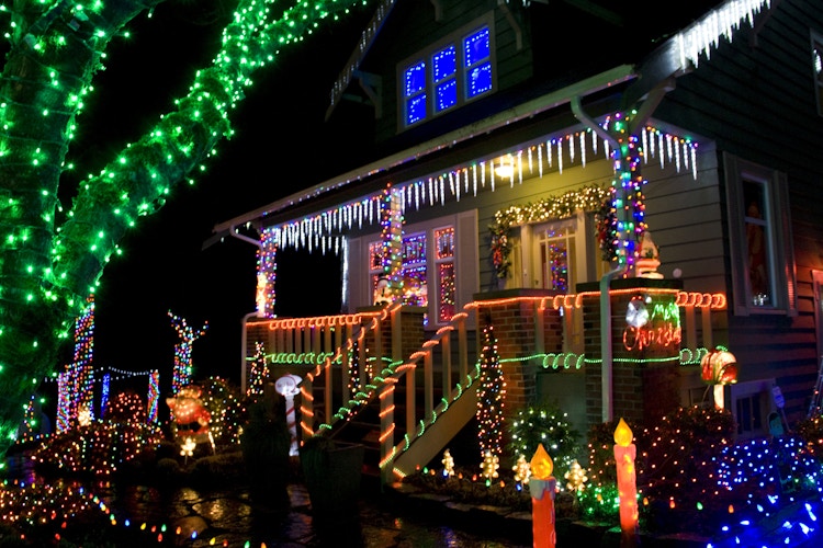 a house is lit up with colorful christmas lights