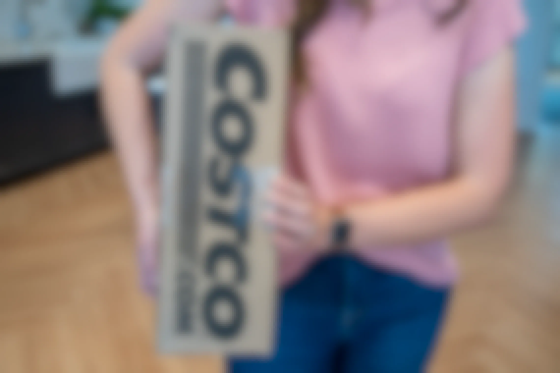 A person holding a Costco.com online order box.