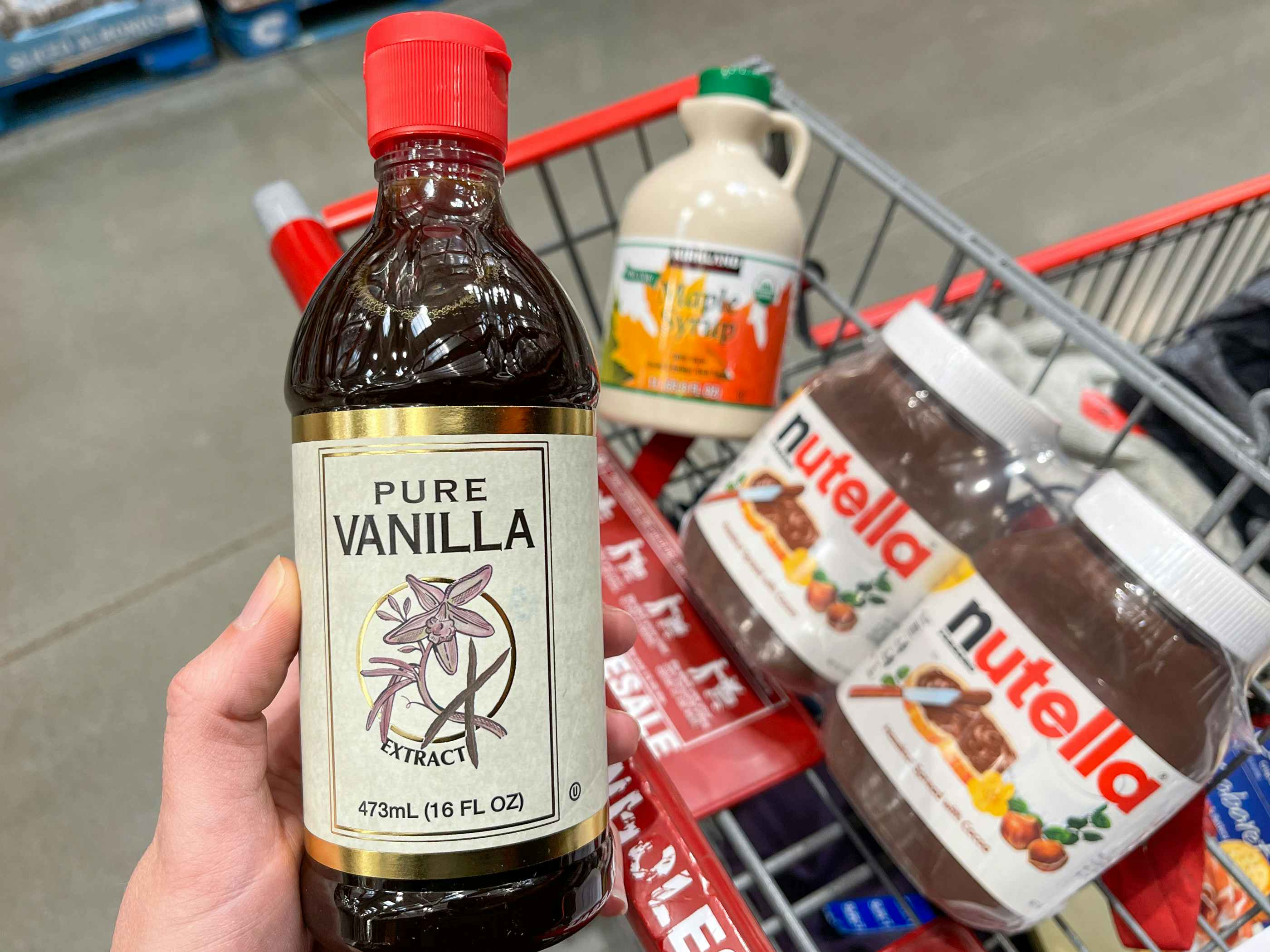 Vanilla, maple syrup, and Nutella in a cart at Costco.