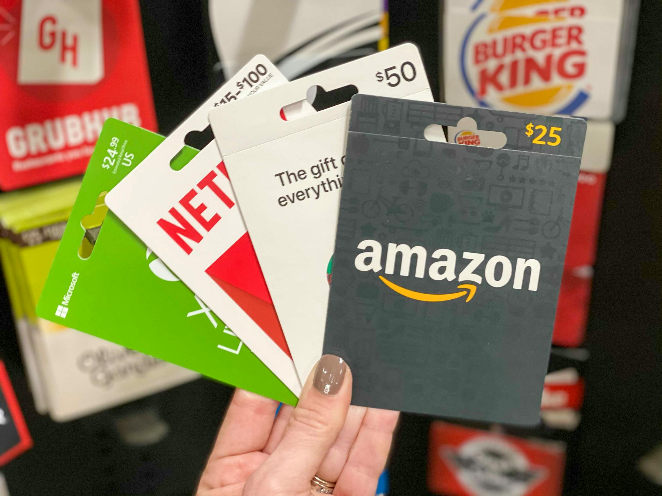 Gift cards held in front of the gift card display at Dollar general