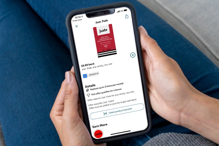 woman holding phone with ibotta app showing mooney back for buying just a period tampons