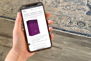 woman holding iphone with poise free sample on screen