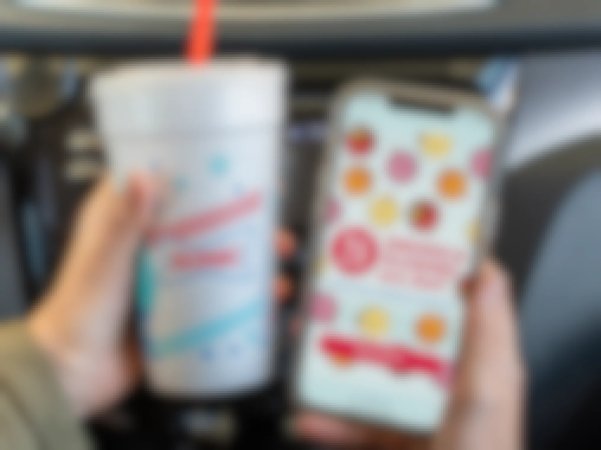 1/2 drinks and slushes all day" ad inside the Sonic app on a cell phone, next to a sonic cup.