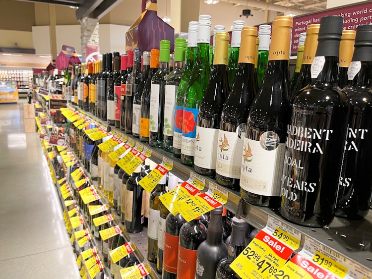 A grocery store aisle filled with wine