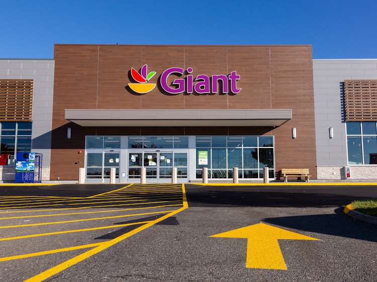 Giant foods, store front with large yellow direction arrow pointing towards the store.