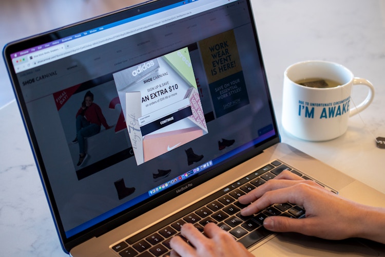 A person entering their email into the shoe carnival email signup. 