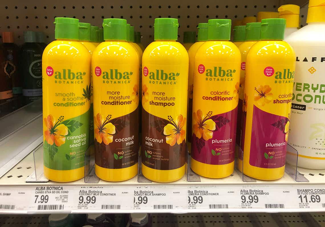 Bottles of Alba Botanica haircare products on a shelf at Target.
