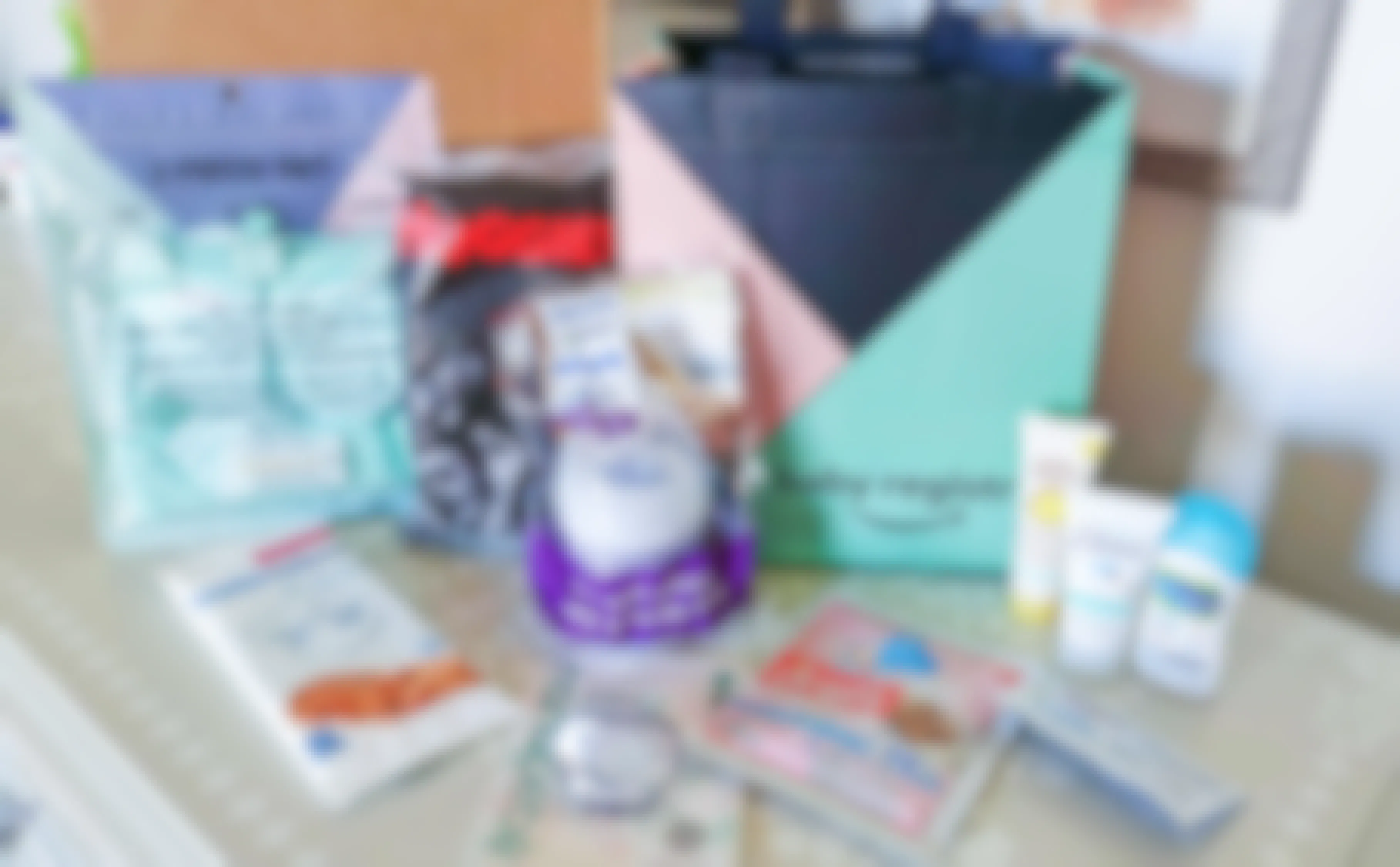 An Amazon Baby Registry reusable shopping bag sitting on a table surrounded with various baby products.