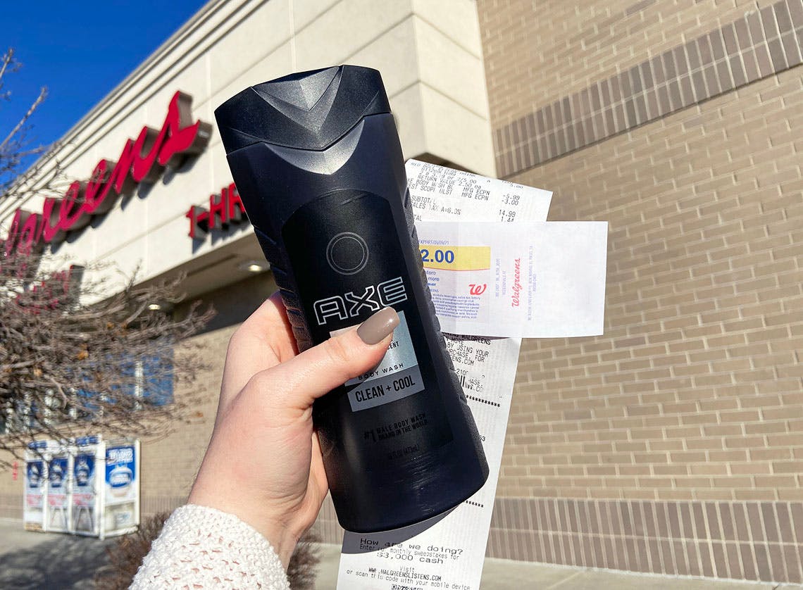 Someone holding Axe body wash outside a Walgreens