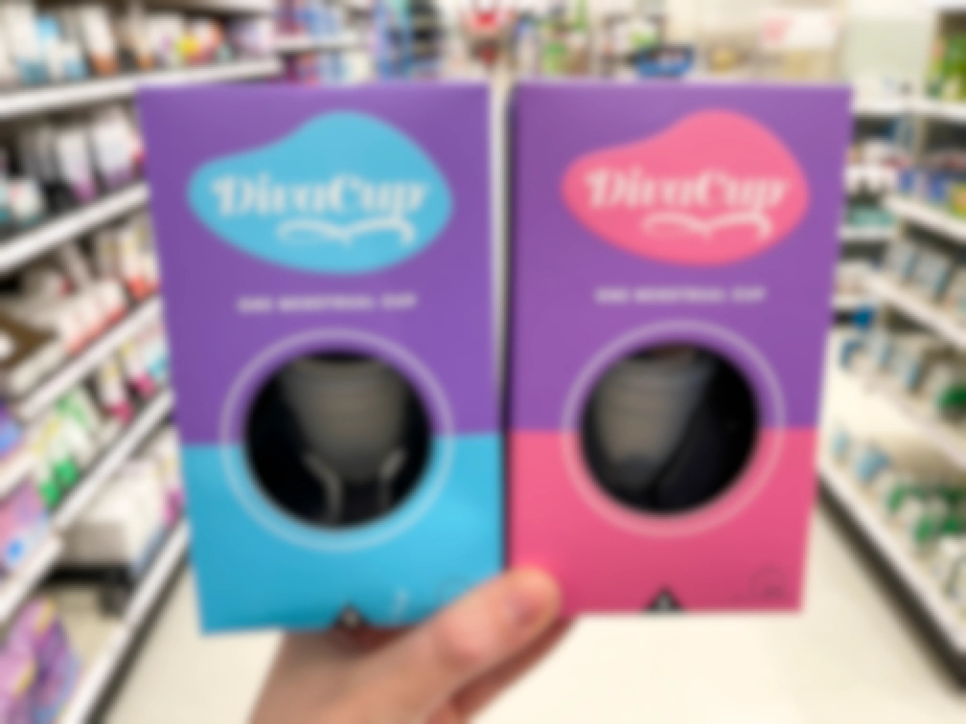 A person holding two DivaCup menstrual cups at Target