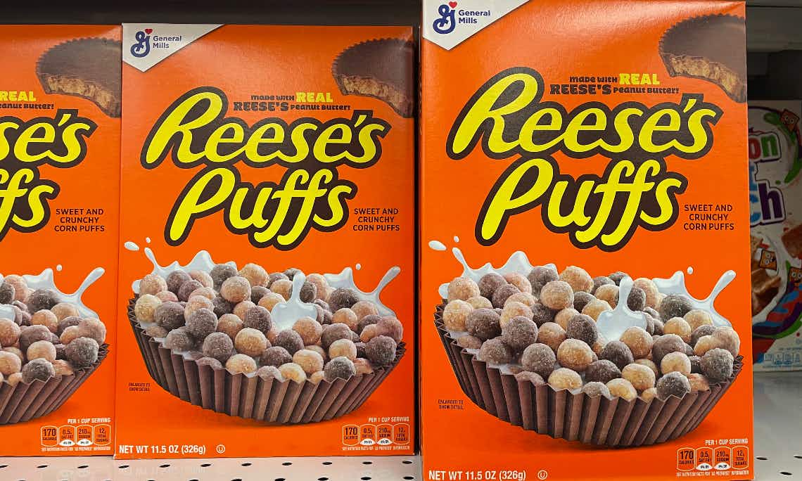 A row of Reese's puffs cereal on a store shelf.
