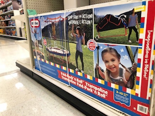 A boxed Little Tikes Fold-Pack n' Roll trampoline on a shelf at Target.