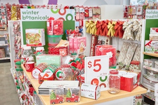 Christmas merch on a table with a sign that says $5 or less